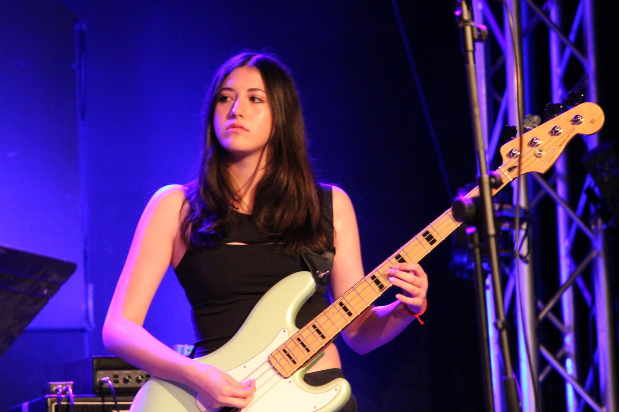 Ava on stage with bass